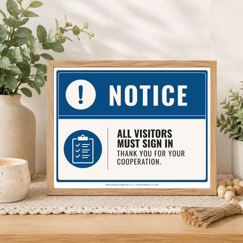 A framed visitor sign-in notice with a blue and white design sits on a wooden table in a styled home setting with plants and a candle.