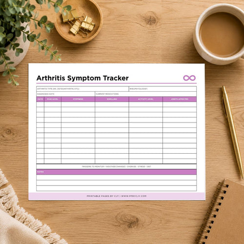 A printable Arthritis Symptom Tracker sheet displayed on a wooden desk with a coffee cup, plant, gold clips, pen, and notebook around it.