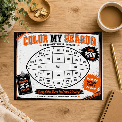 A rectangular fundraising game board titled 'COLOR MY SEASON' lies on a wooden tabletop, surrounded by a coffee cup, plant leaves, a bowl with gold coins, and a spiral notebook. The board features a football-shaped scoring area with dollar amounts and promotional text blocks.