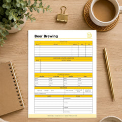 A printable beer brewing log sheet displayed on a wooden desk flat-lay. The white paper template features yellow highlighted sections for tracking beer batch details, shown alongside a coffee cup, gold binder clip, notebook, pen, and green plant.