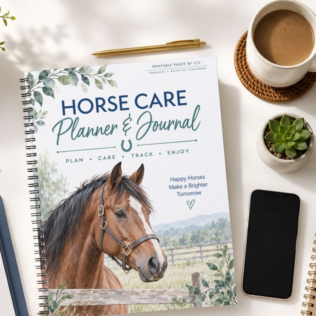 A spiral-bound Horse Care Planner & Journal lies on a white tabletop, surrounded by a coffee cup, pen, smartphone, and small potted succulent. The cover shows a brown horse portrait with the title 'HORSE CARE Planner & Journal' and decorative greenery.