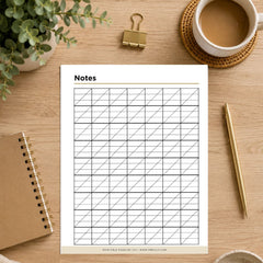A printable notes page with a grid layout, styled in a flat-lay on a wooden desk alongside a notebook, pen, binder clip, plant, and a cup of coffee.