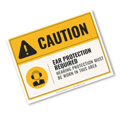 A yellow and white safety sign with black text reading 'CAUTION' and 'EAR PROTECTION REQUIRED / HEARING PROTECTION MUST BE WORN IN THIS AREA,' plus a warning icon and a headset symbol. The sign is shown at an angle on a plain white background.
