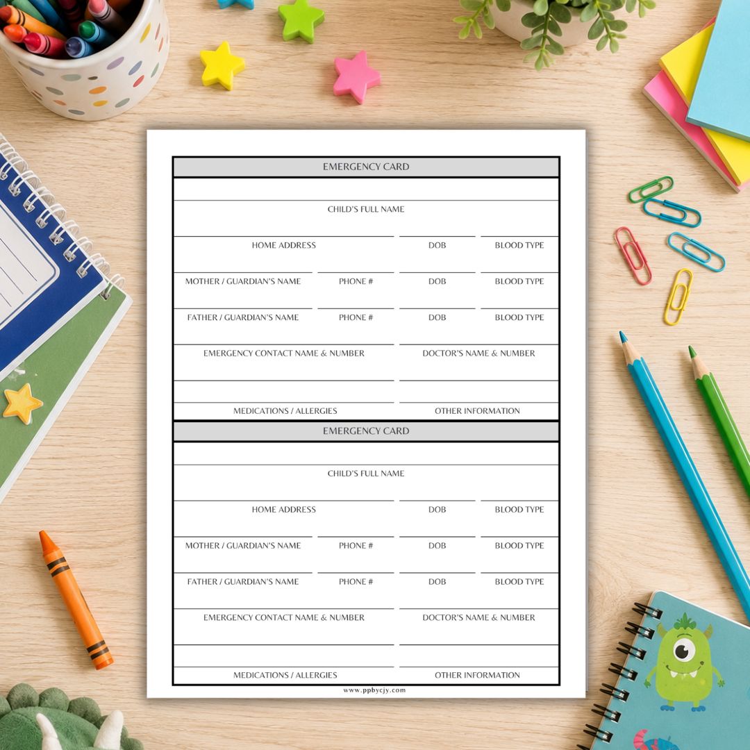 A printed emergency card template sheet displayed on a light wood desk surrounded by school and office props including notebooks, pencils, paper clips, and a crayon.