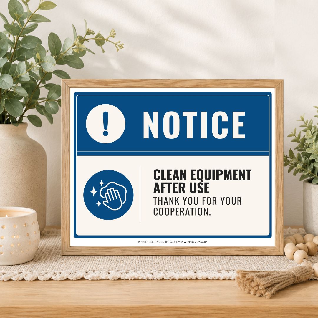 A framed printed notice sign on a tabletop, styled with plants, a candle, and decorative beads. The sign reads “NOTICE” and “CLEAN EQUIPMENT AFTER USE THANK YOU FOR YOUR COOPERATION.