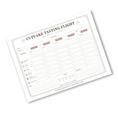 A printable 'Cupcake Tasting Flight' chart template shown on a clean white background. The planner-style sheet features columns for days of the week, rating scales, and fields for notes and scores, with a subtle drop shadow.