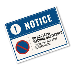 A rectangular warning sign with a blue header reading 'NOTICE' and a white lower section containing the text 'DO NOT LEAVE MACHINE UNATTENDED THANK YOU FOR YOUR COOPERATION.' A red-and-blue prohibition symbol appears on the left.