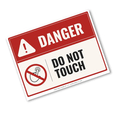 A rectangular warning sign with a red header reading DANGER and a white lower section that says DO NOT TOUCH, plus a crossed-out hand icon. The sign is shown at an angle on a plain white background.