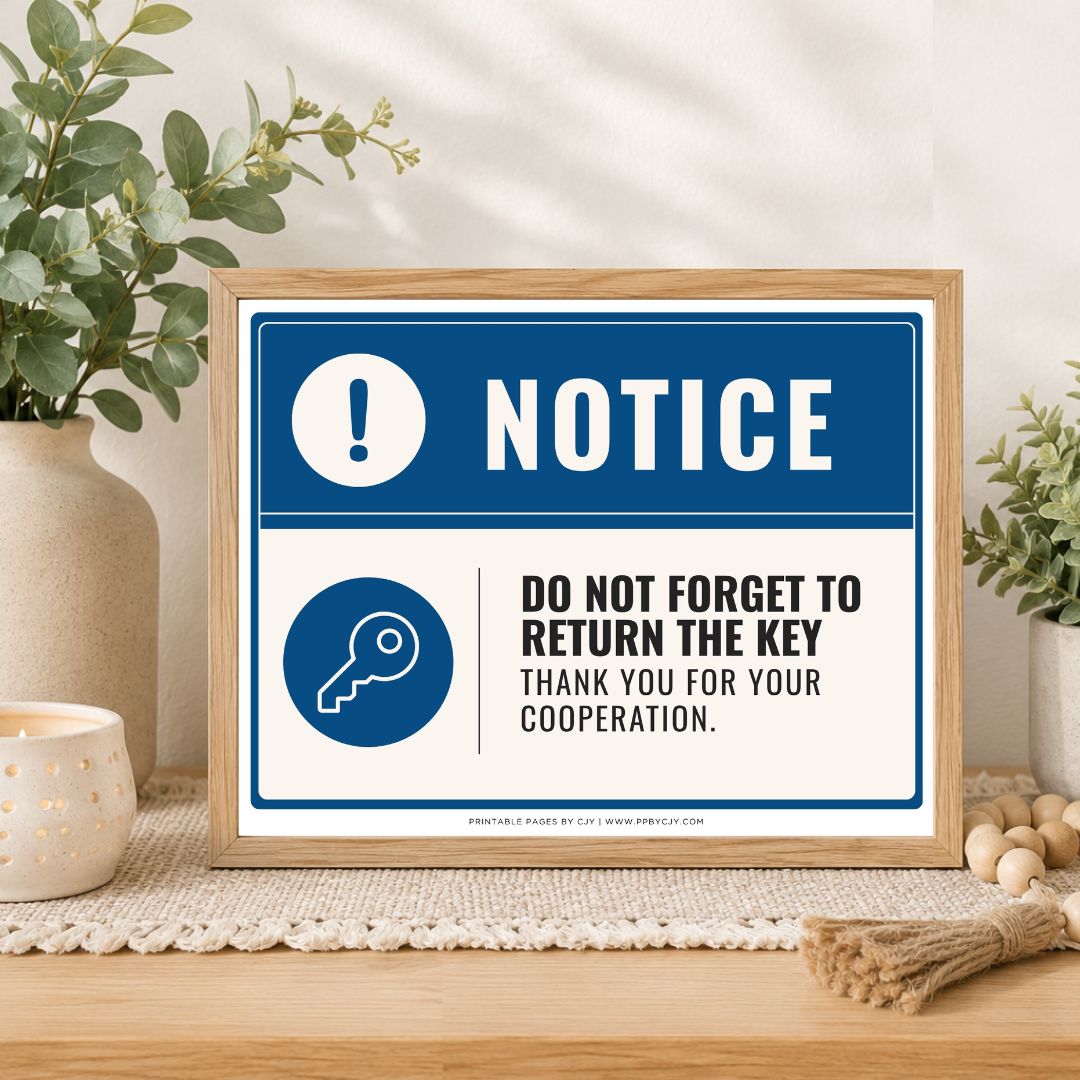 A framed printed notice sign on a wooden table, styled with plants, a candle, and decorative beads. The sign has a blue and white design with text reading 'NOTICE' and 'DO NOT FORGET TO RETURN THE KEY THANK YOU FOR YOUR COOPERATION.