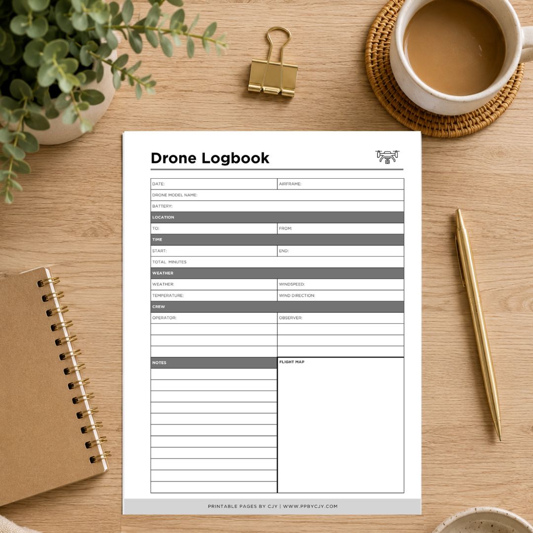 A printable drone logbook sheet displayed on a wooden desk flat-lay with a coffee cup, binder clip, plant, notebook, and pen.