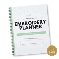 A spiral-bound cross stitch embroidery planner shown at an angle on a white background. The cover is white with a subtle light green geometric pattern, bold black text reading 'EMBROIDERY PLANNER,' a light green horizontal bar, and a gold circular badge in the lower right corner that says '10+ PAGES.