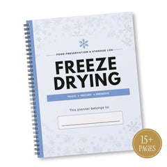 A spiral-bound 'Freeze Drying' food preservation and storage log planner with a white cover decorated with light blue snowflakes, a blue spine, and bold black text. A gold circular badge in the bottom right corner reads '15+ PAGES'.