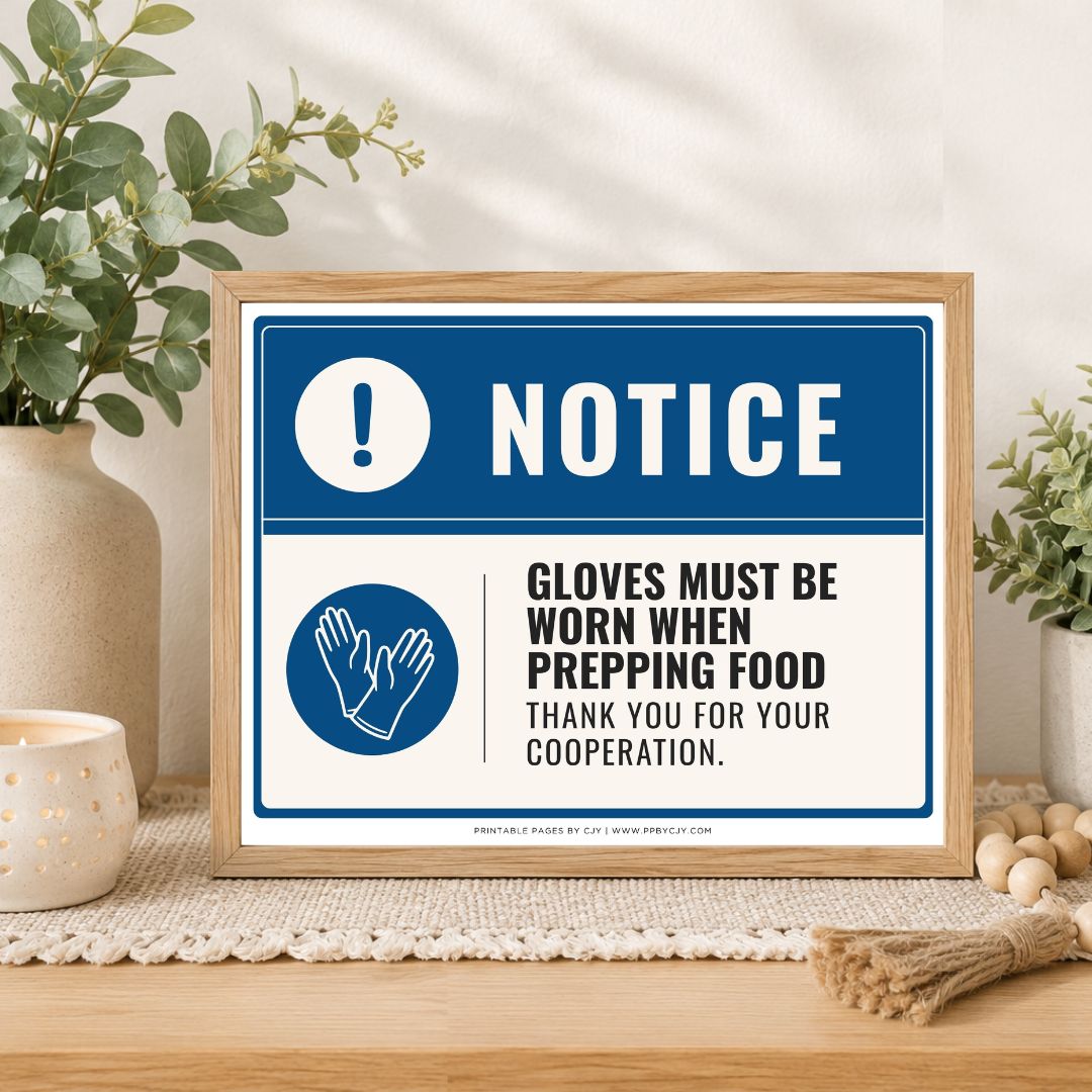A framed printed notice sign on a tabletop in a styled interior setting. The sign has a blue border, a blue header with white 'NOTICE' text, and a white lower section with a blue hand icon and black text reading 'GLOVES MUST BE WORN WHEN PREPPING FOOD THANK YOU FOR YOUR COOPERATION.