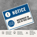 Printable Microwave in Use in This Area notice sign featuring a professional blue notice design, microwave symbol, and appliance location sign for break rooms, employee kitchens, and shared food preparation areas.