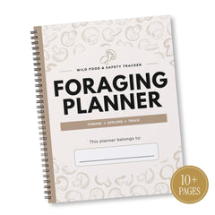 A spiral-bound Foraging Planner notebook shown at an angle on a white background. The cover is cream-colored with light beige mushroom illustrations, bold black text reading 'FORAGING PLANNER,' and a gold circular badge in the bottom right corner that says '10+ PAGES.
