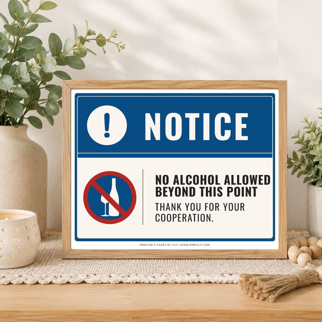 A framed novelty warning sign displayed on a wooden table in a styled home setting. The sign features a blue and white design with the text 'NOTICE' and 'NO ALCOHOL ALLOWED BEYOND THIS POINT THANK YOU FOR YOUR COOPERATION.