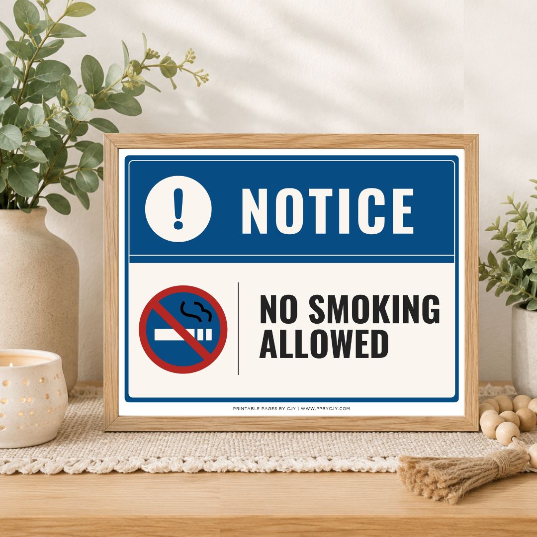 A framed 'No Smoking Allowed' sign displayed on a wooden table in a styled home setting with plants and a candle.
