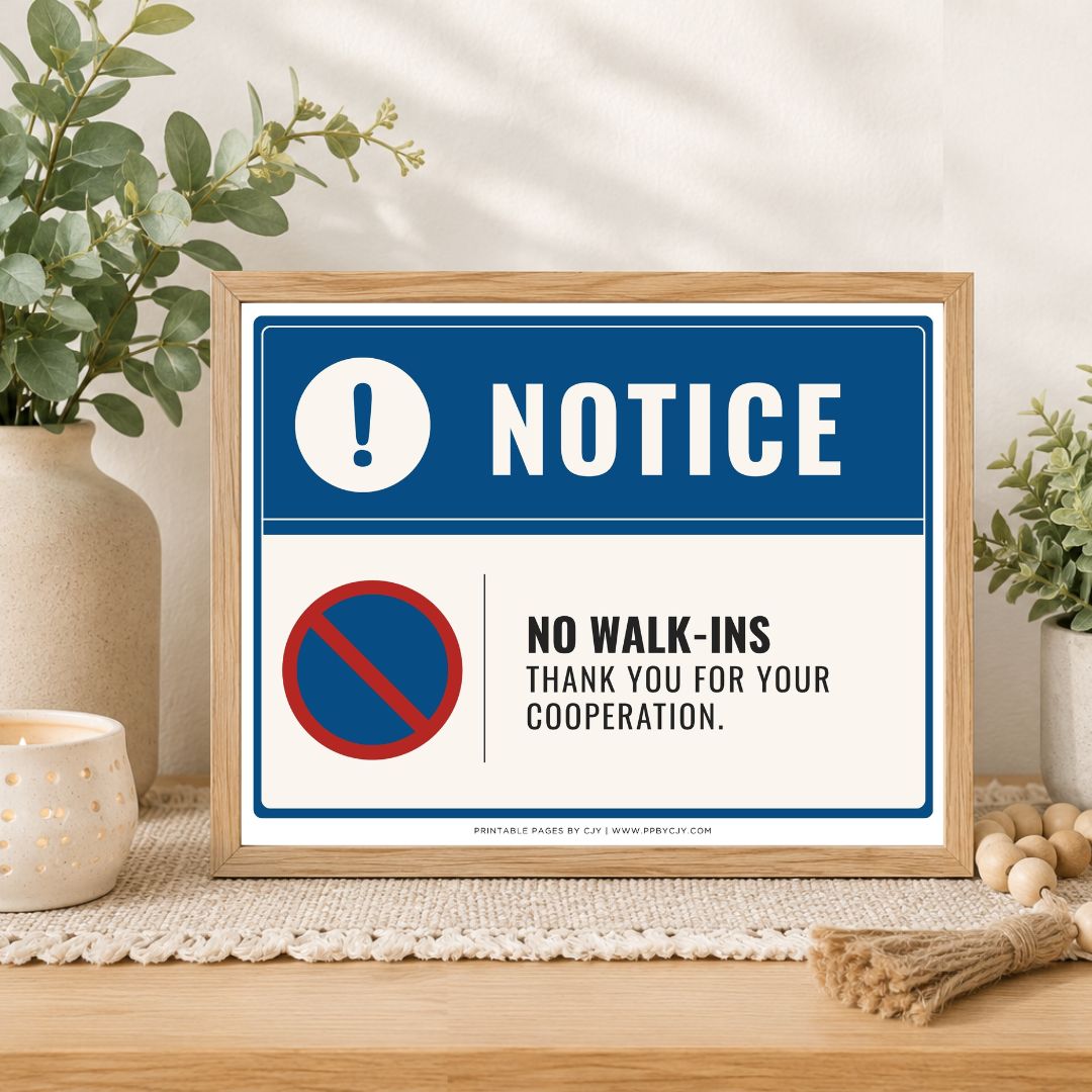 A framed printed notice sign on a tabletop in a styled interior setting. The sign has a blue header with a white exclamation circle and the word NOTICE, and a white lower section with a red-and-blue no symbol and the text NO WALK-INS THANK YOU FOR YOUR COOPERATION.
