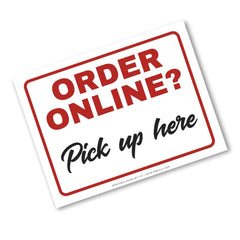 A square white sign with rounded corners featuring the text 'ORDER ONLINE?' in large red letters and 'Pick up here' in black script, outlined by a red border, shown on a white background.