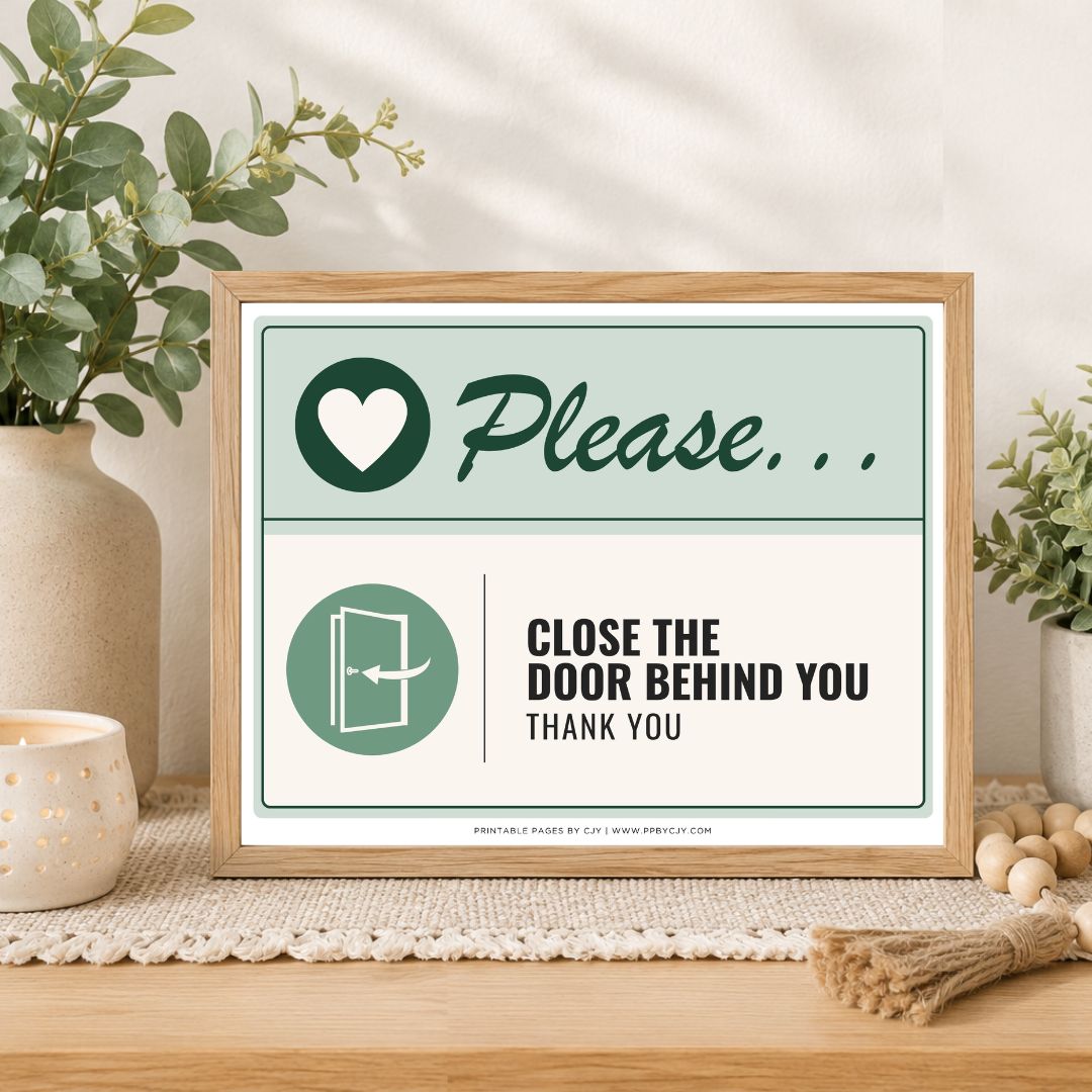 A framed printed sign on a tabletop in a styled interior setting. The sign has a light wood frame and reads 'Please.