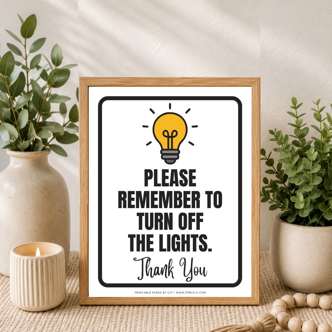 A framed typographic wall sign with a light bulb graphic and the text 'PLEASE REMEMBER TO TURN OFF THE LIGHTS. Thank You' sits on a tabletop styled with potted green plants, a candle, and a wooden bead runner.