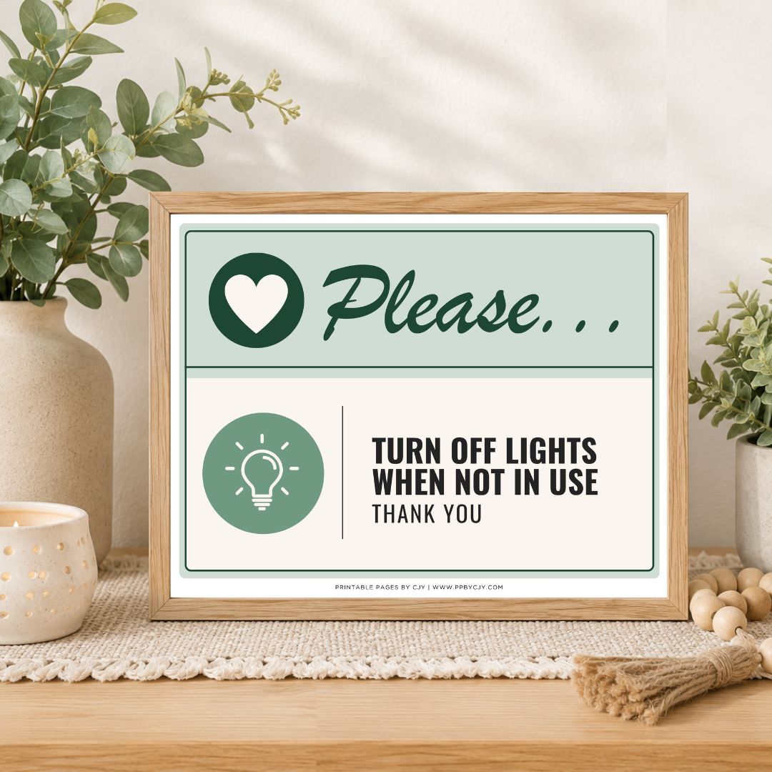 A framed printable sign on a wooden table in a styled room setting. The sign has a light wood frame and a two-tone design with sage green and cream sections.