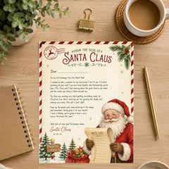 A Christmas-themed letterhead or print displayed on a wooden desk, featuring a festive letter from Santa Claus with red-and-white holiday borders, pine branches, ornaments, and an illustration of Santa holding a sack and letter. The print is styled in a flat lay with a coffee cup, plant leaves, a gold clip, a spiral notebook, and a gold pen around it.
