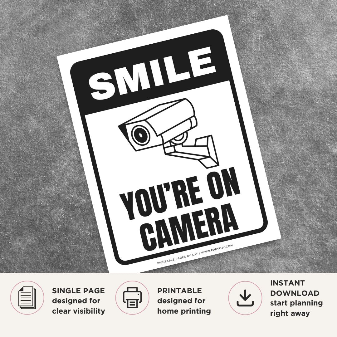Printable Smile You're on Camera sign featuring a bold black design, security camera graphic, and surveillance notice for retail stores, offices, warehouses, parking areas, and commercial properties.