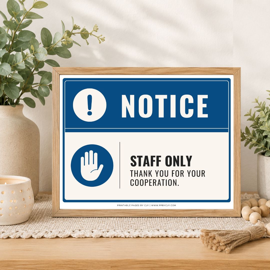 A framed printed notice sign on a tabletop in a styled interior setting. The sign has a blue header with a white exclamation mark and the word NOTICE, and a white lower section with a blue hand icon and the text 'STAFF ONLY THANK YOU FOR YOUR COOPERATION.