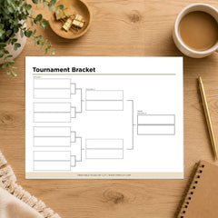 A printable tournament bracket template sheet displayed on a wooden desk with styled office props including a cup of coffee, a notebook, a pen, and a small plant.