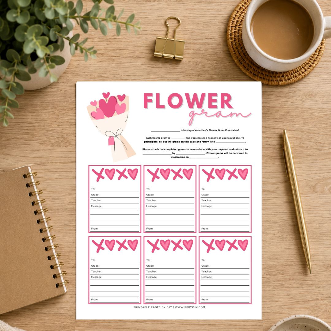 A printable 'Flower Gram' game card styled in a flat-lay desk scene on a wooden table, surrounded by a coffee cup, binder clip, plant, notebook, and pen.