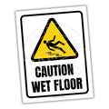 White sign with yellow and black caution triangle with person slipping, wording stating "caution wet floor"