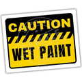 Caution wet paint sign with yellow and black colors on a white background