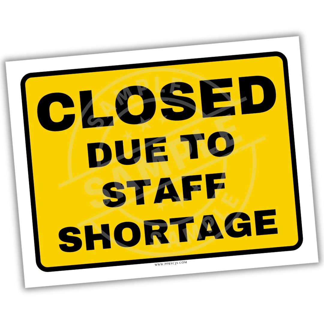 Yellow sign with black text 'CLOSED DUE TO STAFF SHORTAGE' on a white background