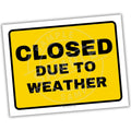 Yellow sign with 'CLOSED DUE TO WEATHER' text on a white background