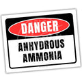 Warning sign for anhydrous ammonia with red border and white text on a white background