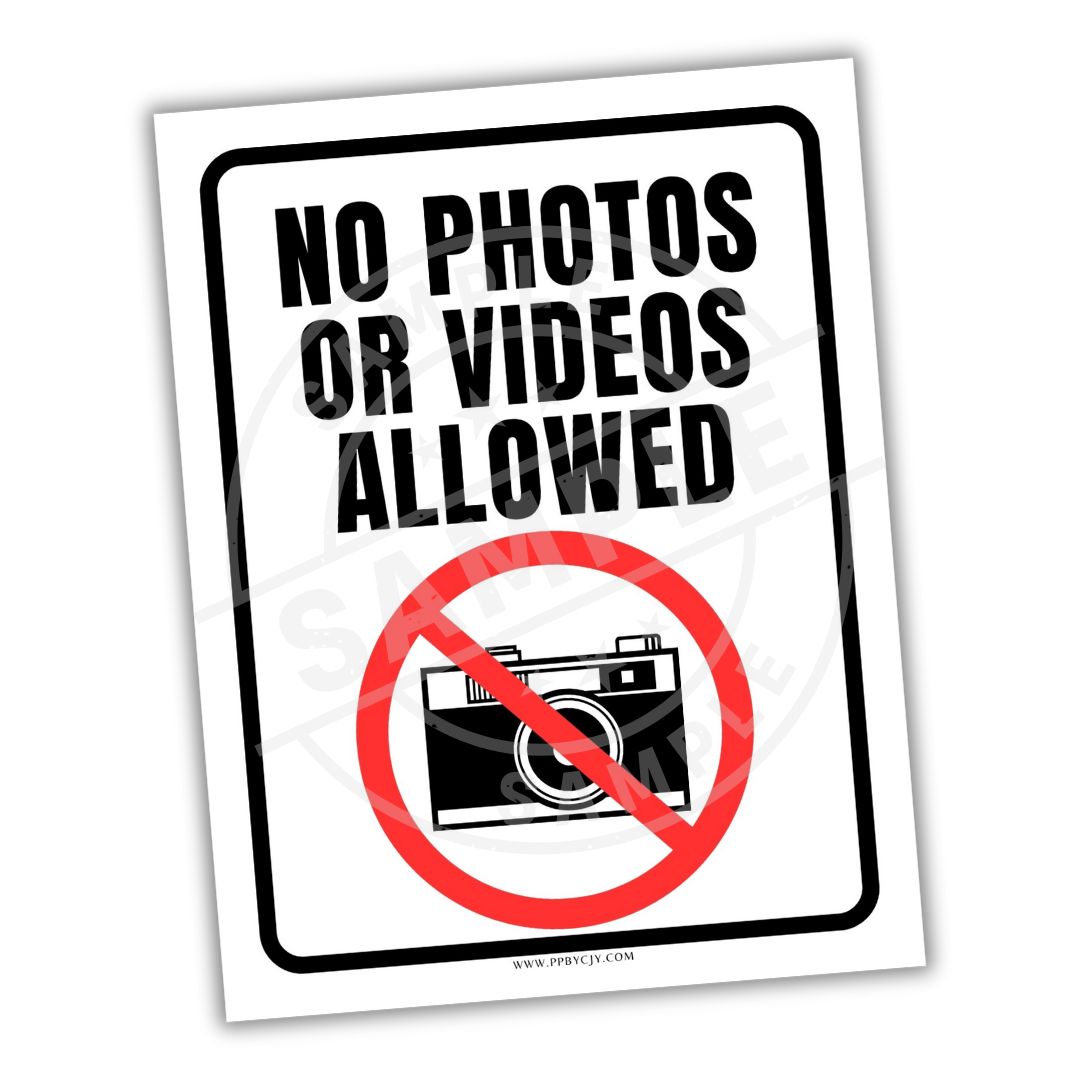 Sign with 'No Photos or Videos Allowed' text and camera icon on a white background