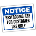 Notice sign indicating restrooms are for customer use only with blue border and white background.