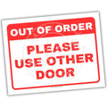 Sign reading 'Out of Order Please Use Other Door' with a red border on a white background