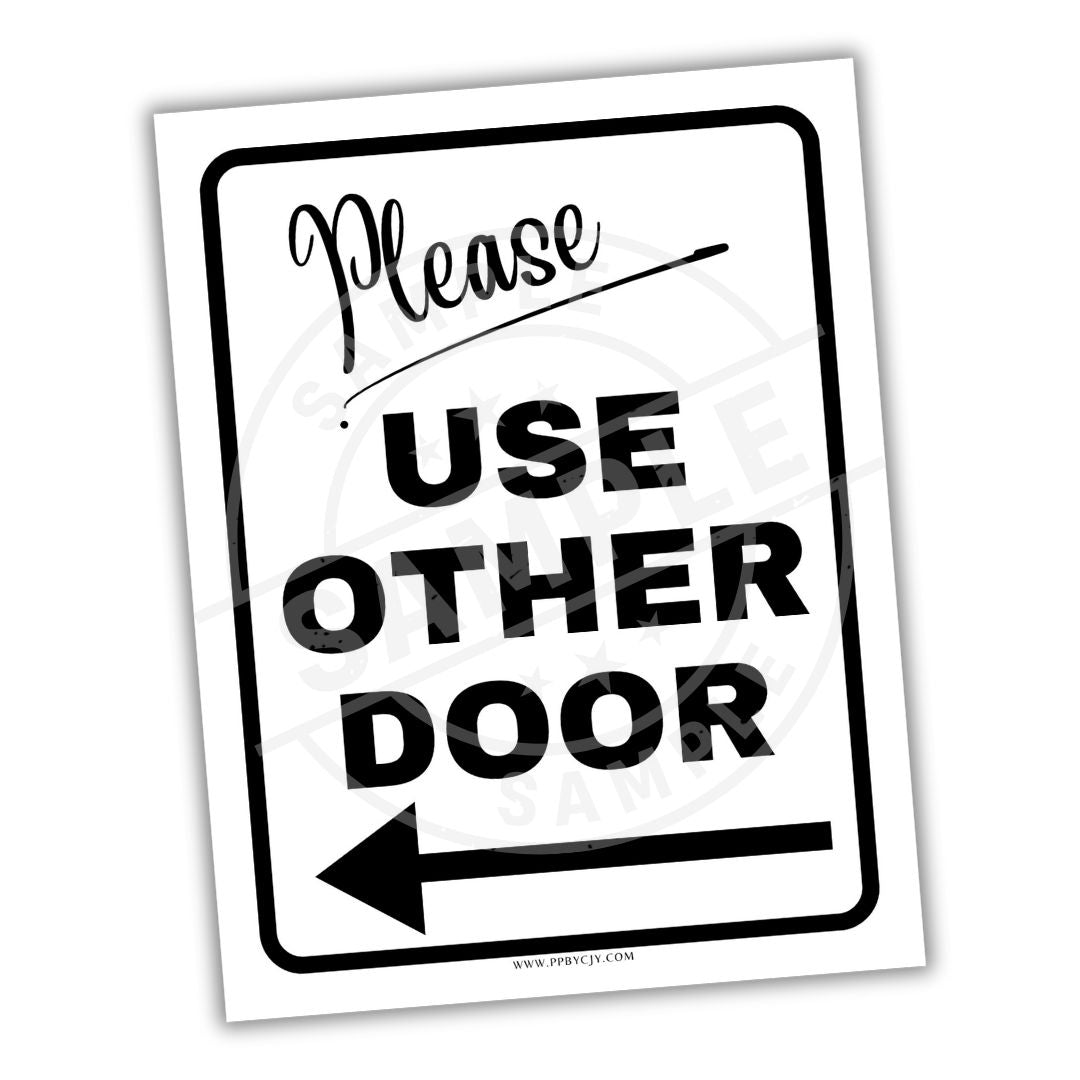 Sign with text 'Please Use Other Door' and an arrow on a white background