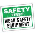 Safety sign with 'Safety First' and 'Wear Safety Equipment' text on a white background