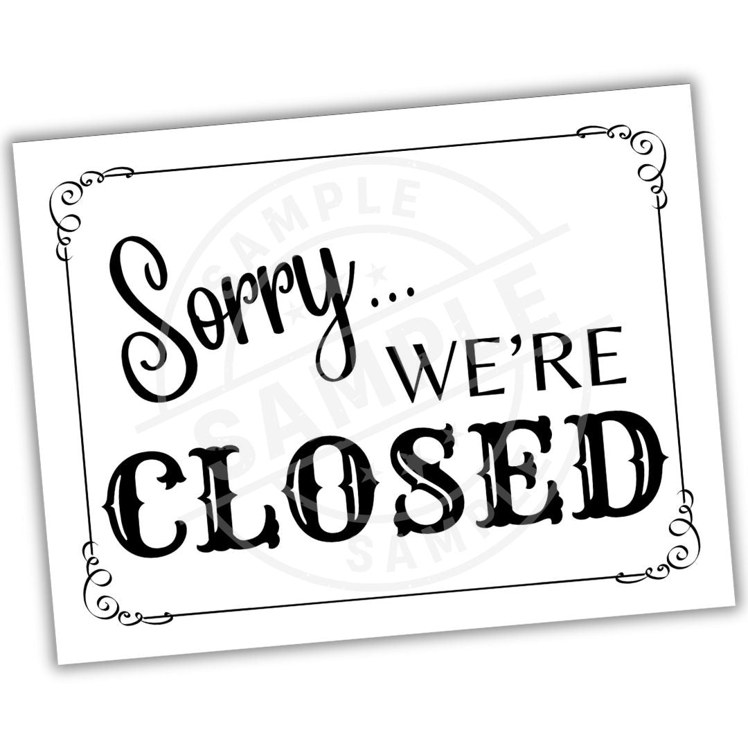 Sign with 'Sorry... We're Closed' text on a white background
